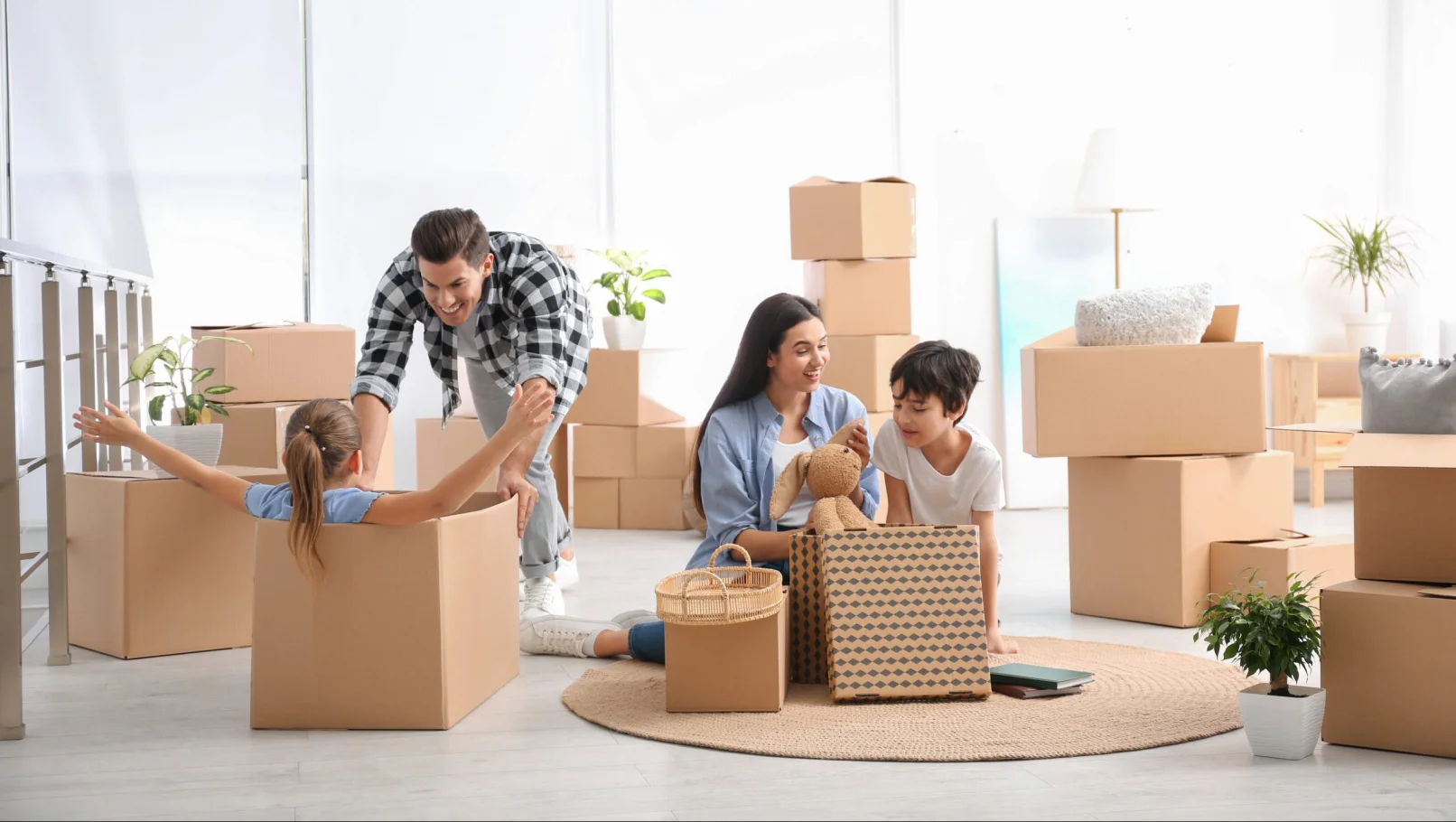 family unpacking moving boxes at their new home